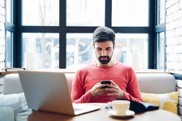 Millennial Male Holding Smartphone Getting Message Confirmation Making Transaction Laptop — Stock Photo, Image