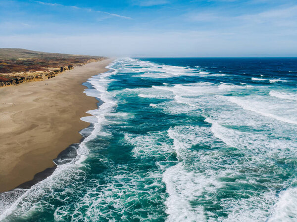 Birds eye view of beauty of wild island near Pacific ocean with sea breeze and foamy waves, aerial view of coastal landscape in California, breathtaking seaside with beautiful nature