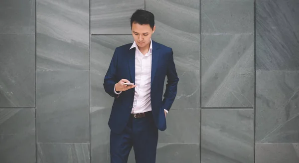 Serious Attentive Handsome Asian Man Suit Messaging Smartphone While Standing — Stock Photo, Image