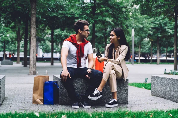 Man Eyeglasses Woman Trendy Clothes Sitting Stone Bench Paper Bags — Stock Photo, Image