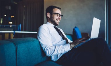 Keyifli profesyonel iş pazarlama uzmanının laptoptaki 4G bağlantısını kullanan müşteriden aldığı olumlu e-posta, resmi web sitesindeki mutlu adam