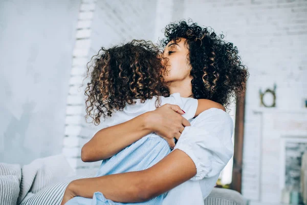 Beautiful Loving Curly Woman Embracing Little Curly Girl Kissing Eyes — Stock Photo, Image