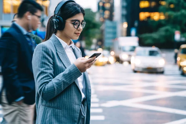 Stylish Young Female Glasses Gray Suit Wearing Wireless Headphones Using — Stock Photo, Image