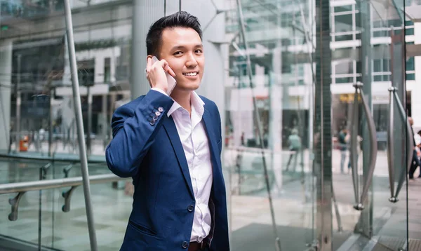 Positive Asian Businessman Dark Blue Business Suit Talking Phone Entrance — Stock Photo, Image