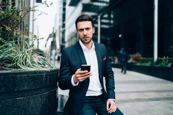 Adult Man Suit Frowning Looking Camera While Sitting Flowerbed Browsing — Stock Photo, Image