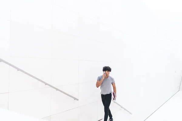 Cheerful Modern Ethnic Man Chatting Smartphone While Climbing Stairs White — Stock Photo, Image