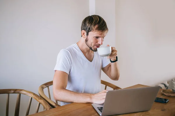 Smiling Focused Bearded Man Casual Wear Slurping Hot Coffee Mug — Stock Photo, Image