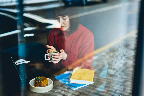 Glass View Young Woman Red Sweater Cup Hot Coffee Working — Stock Photo, Image