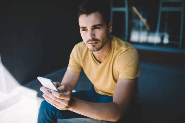 Serious Worried Young Male Casual Clothes Holding Smartphone Hands Looking — Stock Photo, Image