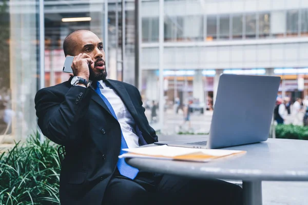 Vista Lateral Funcionário Afro Americano Terno Falando Telefone Enquanto Senta — Fotografia de Stock