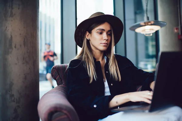 Concentrated Diligent Stylish Woman Hat Sitting Soft Armchair Working Cafe — Stock Photo, Image