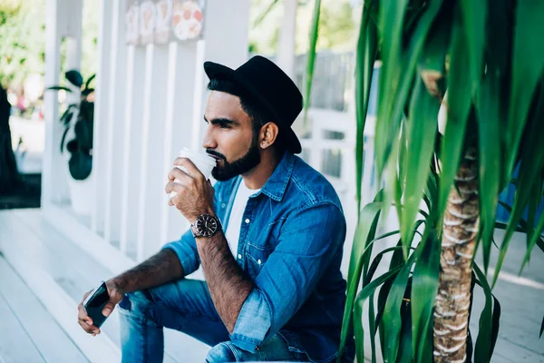 Side View Pensive Bearded Hispanic Man Denim Clothes Hat Drinking — Stock Photo, Image