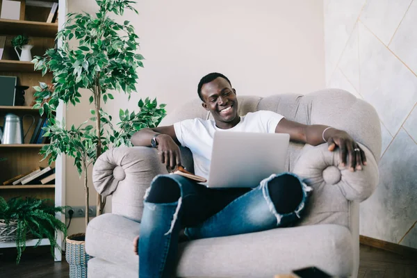 Content Young African American Man Ripped Jeans Relaxing Home Book — Stock Photo, Image