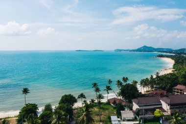 Turkuaz berrak deniz suyuyla beyaz kumsal manzarası. Kumsalda otelleri olan resimli gölün kuş bakışı panoramik manzarası. Tayland 'da nüfuslu bir ada