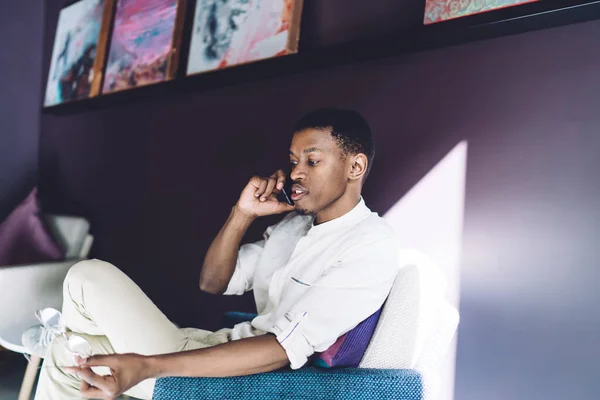 African American Young Man White Clothes Sitting Armchair Crossed Legs — Stock Photo, Image