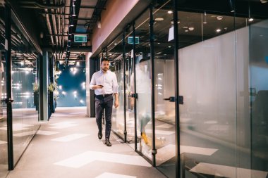 Kafkasyalı bir ofis çalışanı cep telefonu cihazıyla şirket içi toplantısına gidiyor. Mobil cihazlardan gelen bilgileri düşünüyor. Modern teknolojiye sahip zeki bir erkek girişimci.