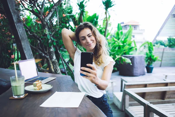 Delighted Businesswoman Wearing White Shirt Touching Hair Taking Selfie Smartphone — Stock Photo, Image