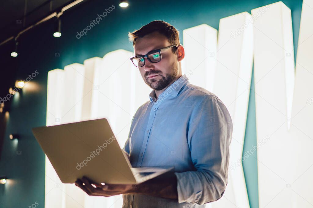 Millennial marketer connecting to corporate wifi internet on modern digital technology for making online capital analytic via online platform for business people, Caucasian man in spectacles browsing