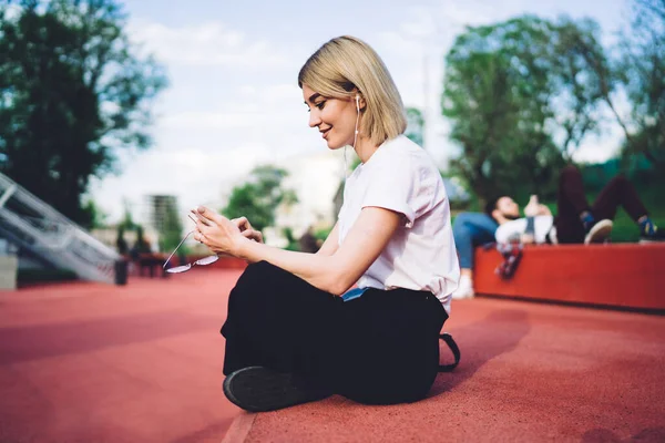 Side View Young Stylish Happy Female Messaging Mobile Phone Listening — Stockfoto