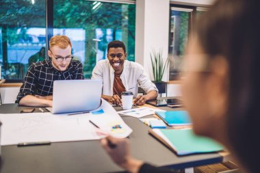 Sosyal platformdan eğlenceli videolar hakkında tartışan neşeli iş arkadaşları modern dizüstü bilgisayarda pozitif şebeke paylaşımının keyfini çıkarıyorlar, mutlu arkadaşlar Netbook 'ta gezinmek için 4G kablosuz ağ kullanıyorlar