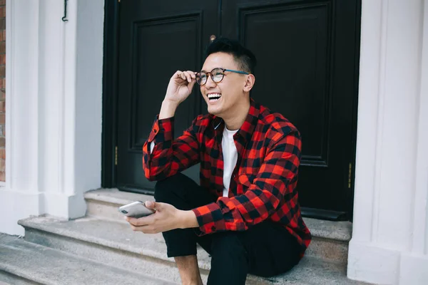 Overjoyed Youthful Ethnic Man Checkered Shirt Laughing Touching Glasses While — Stock Photo, Image