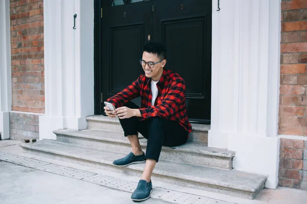 Happy Youthful Ethnic Smart Male Glasses Red Shirt Using Cellphone — Stock Photo, Image