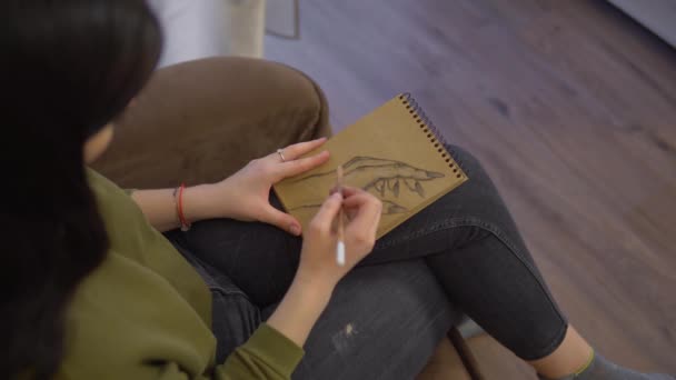 Vrouw kunstenaar tekent een hand in schetsboek door kolen potlood, schilder — Stockvideo