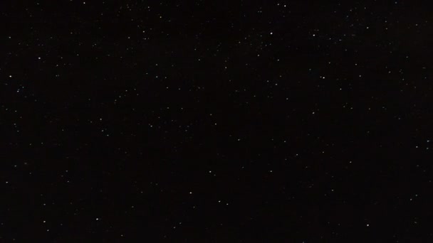 Ночью звезды пролетают над горами и далеким океаном — стоковое видео