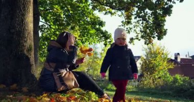 Birlikte sonbahar parkta oynarken. Sonbahar Park doğanın keyfini güzel aile.