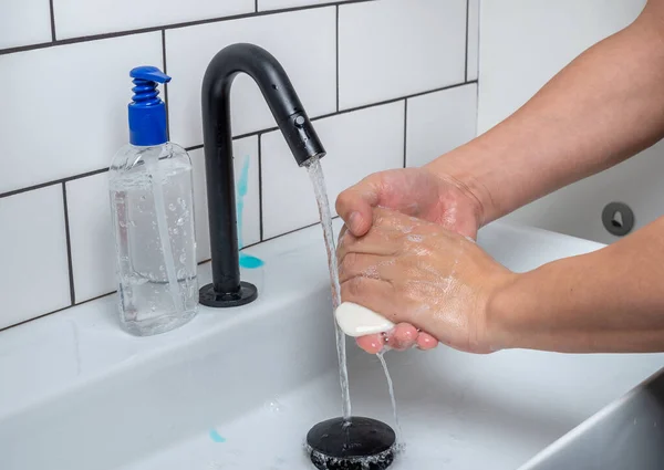 Washing hands with soap to protect against bacteria and viruses