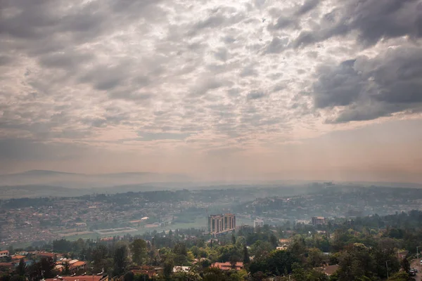 太陽の光がルワンダの丘の上の雲を突破し 遠くへと広がっています — ストック写真
