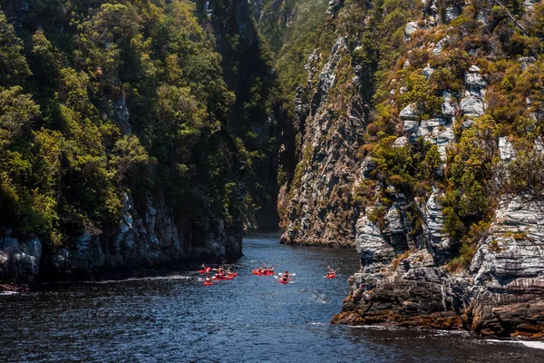A group of kayakers setting out into the Storms River gorge at Storms River Mouth, Tsitsikamma, the Garden Route, South Africa