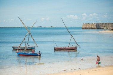 Fishing boats on the beach on a sunny day. Mozambique island or the Island of Mozambique, Ilha de Mozambique, Nampula Province, Africa clipart
