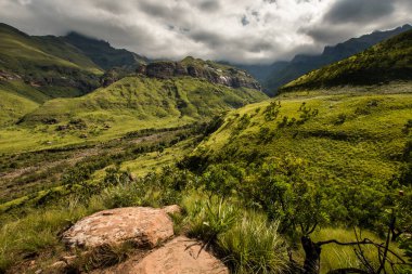 Sweeping mountain sides and cliff faces on the Thukela hike to the bottom of the Amphitheatre's Tugela Falls in the Royal Natal National Park, Drakensberg, South Africa clipart