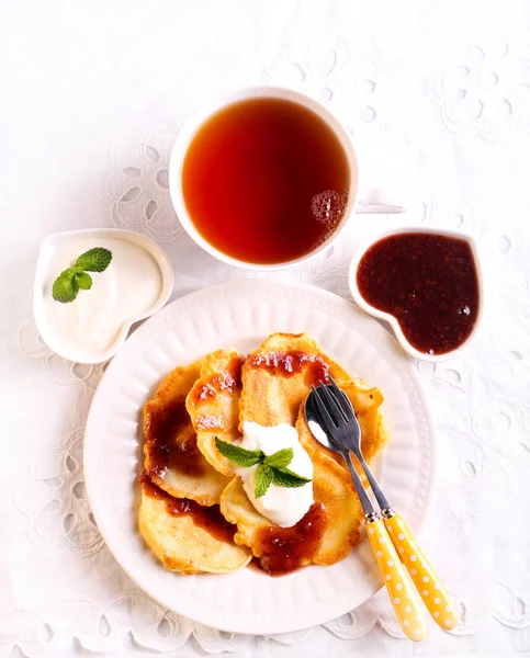 Apple fritters served with jam and yogurt