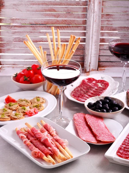 Mix of meat products and  appetizers served — Stock Photo, Image