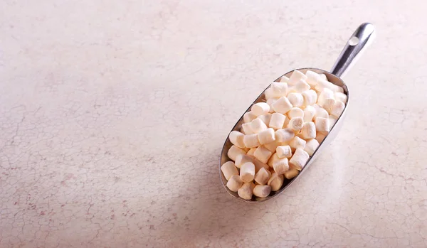 Mini marshmallows in metal scoop — Stock Photo, Image