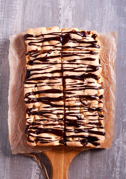 Sponge fruit cake with chocolate drizzle — Stock Photo, Image