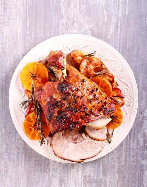 Glazed ham with apples and oranges