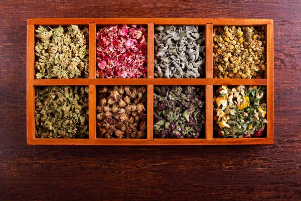 Dried herbs and flowers in wooden box — Stock Photo, Image