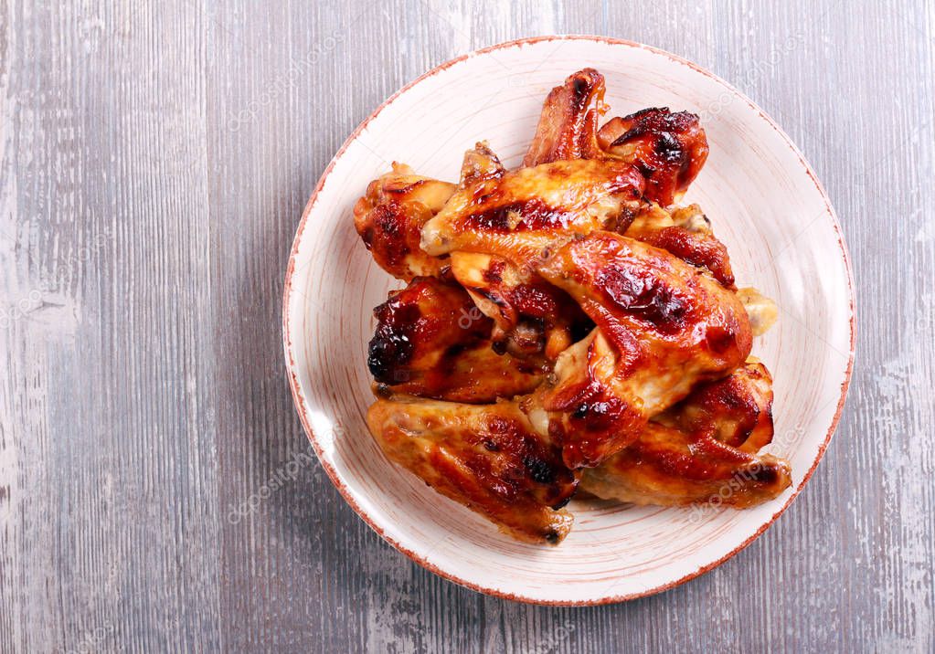 Sticky roast chicken wings on plate