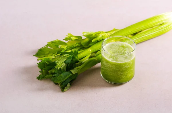 Celery smoothie in glass and celery stalks — Stock Photo, Image
