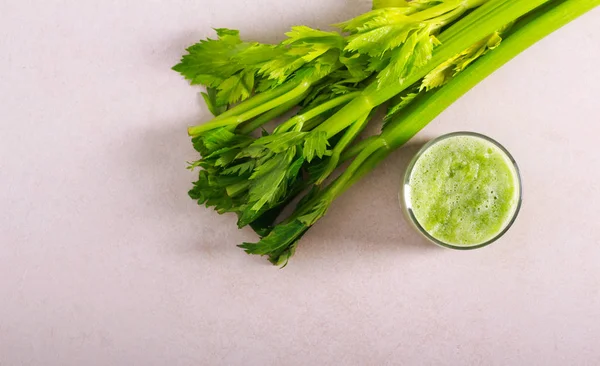 Celery smoothie in glass and celery stalks — Stok Foto