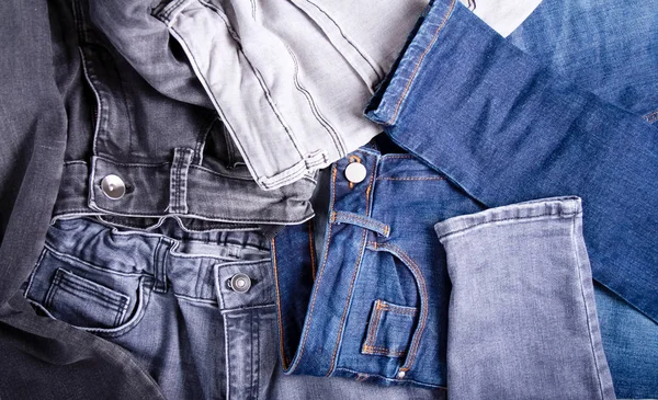 Many different jeans - denim texture — Stock Photo, Image