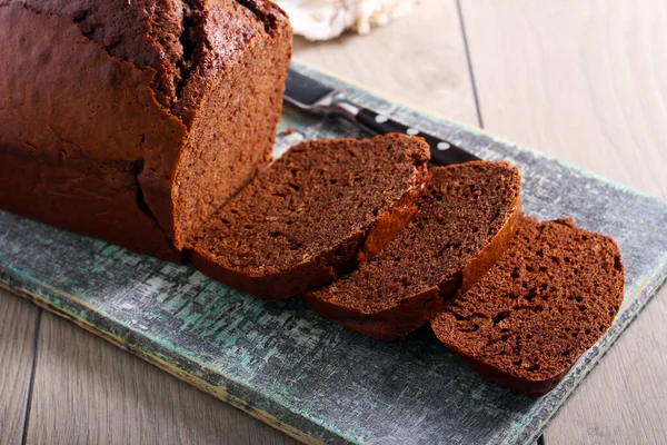 Chocolate spicy bread cake, sliced on board