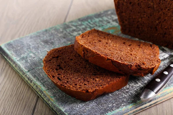 Chocolate spicy bread cake, sliced on board