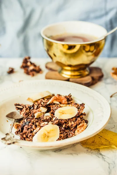 Homemade chocolate granola with banana and peanut butter