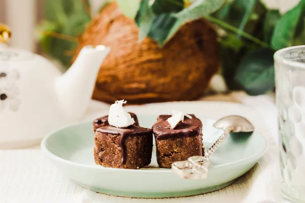 Raw chocolate candy with nuts and coconut, healthy vegan dessert