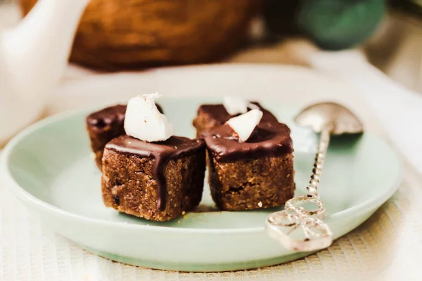 Raw chocolate candy with nuts and coconut, healthy vegan dessert