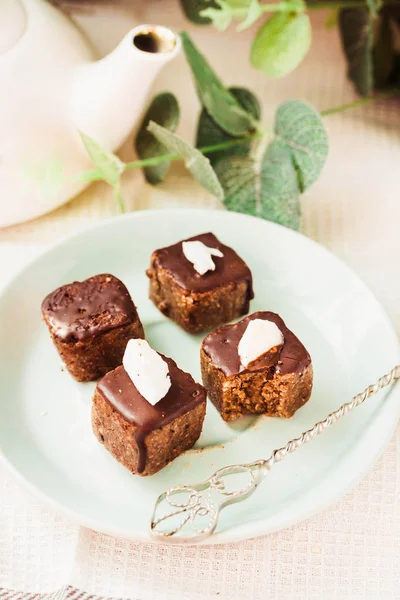 Raw chocolate candy with nuts and coconut, healthy vegan dessert